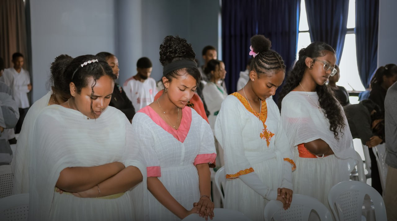 Students standing in worship